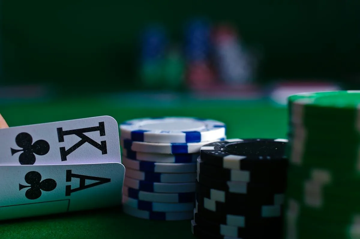 Poker chips and playing cards on a green event table