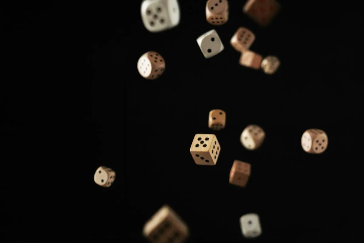 Dice suspended over a dark event backdrop